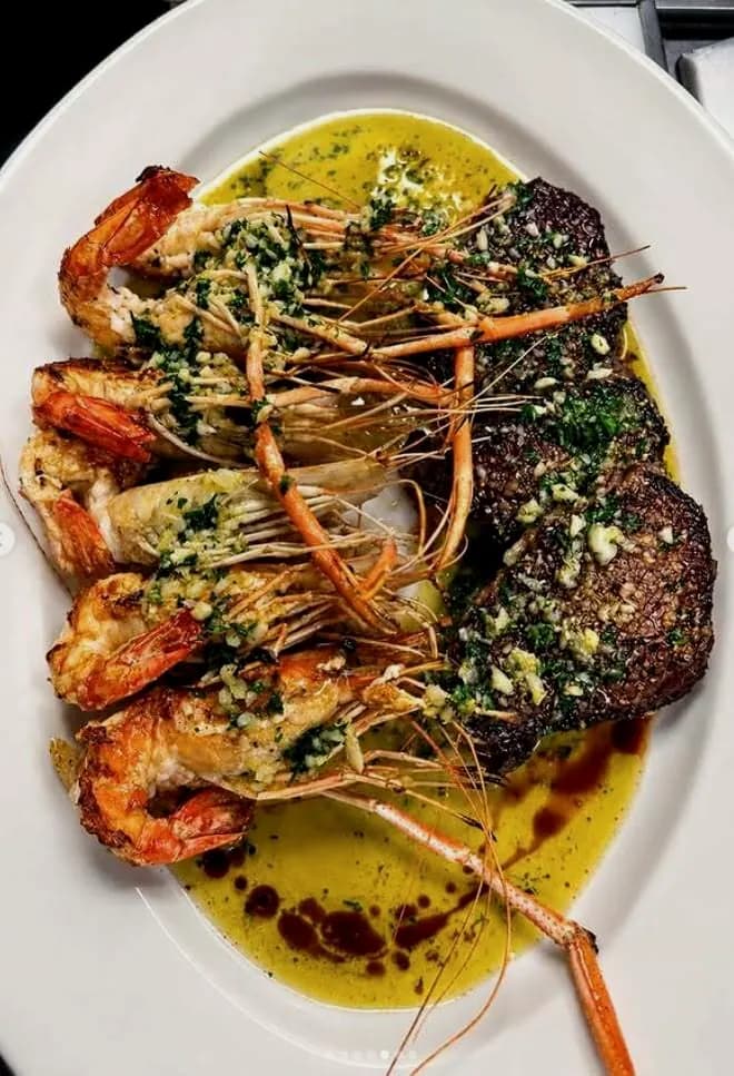 Grilled prawns and beef tenderloin in garlic and parsley olive oil