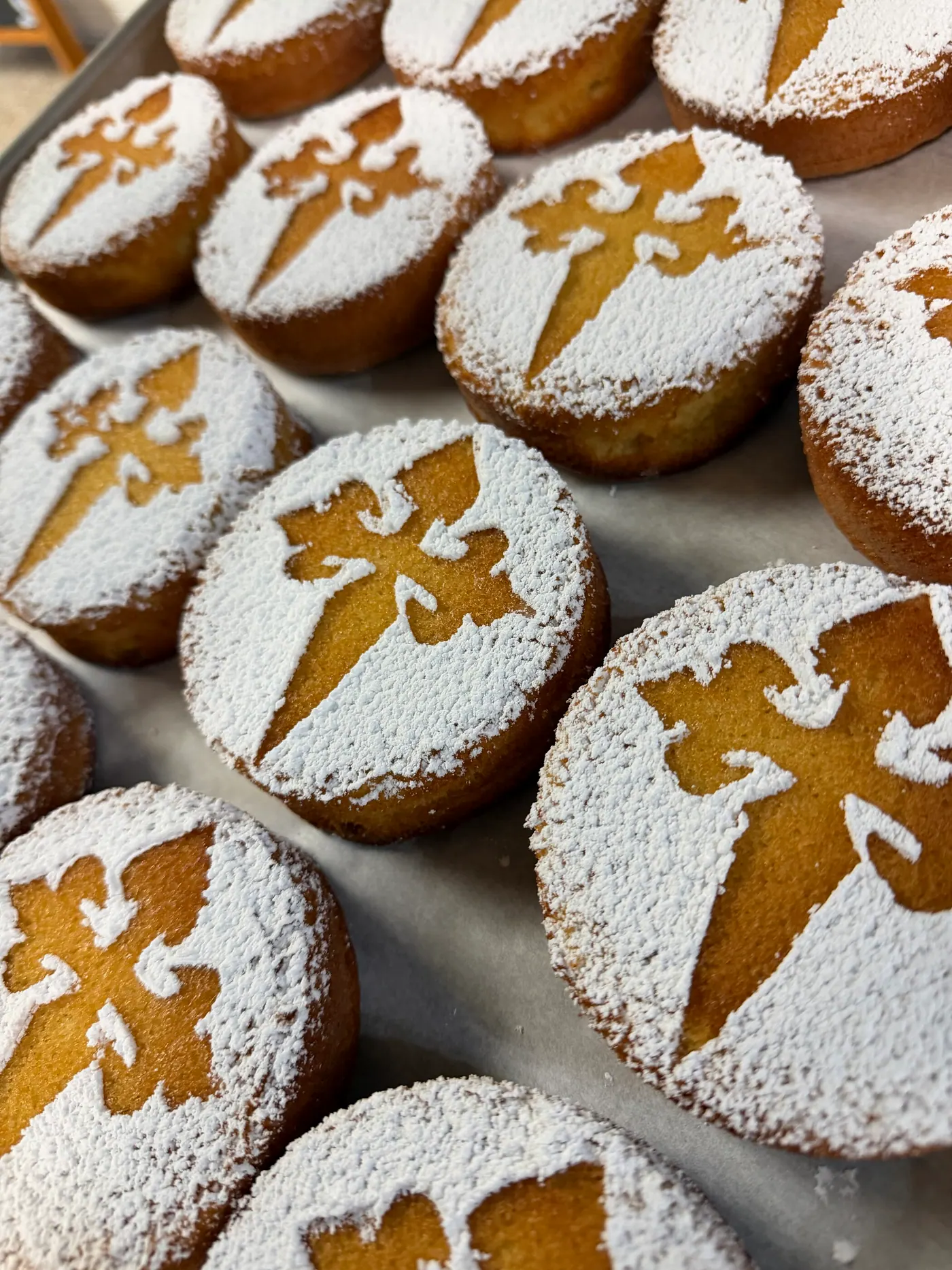 Almond cakes dusted with powdered sugar around the stenciled Cross of Saint James